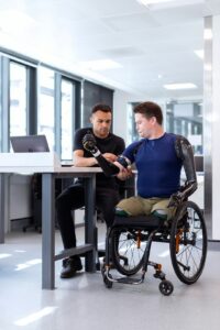 Employee reviews disability insurance documents and pay records at a kitchen table.